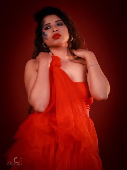 A close-up portrait that feels intimate and dramatic. The way she holds the tulle adds texture and softness to the shot.