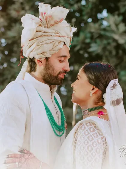 An intimate portrait of the couple after their wedding ceremony. Their serene expressions and close embrace speak volumes about their love.