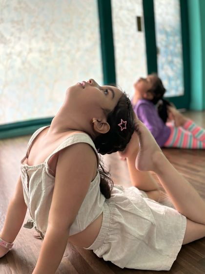 This little powerhouse is working on her back flexibility with a beautiful arch. Our classes for young children focus on safe, age appropriate techniques to build a strong foundation.
