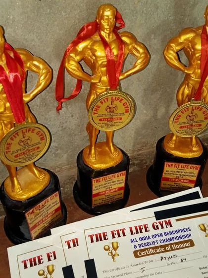 Trophies and certificates from The Fit Life Gym All India Open Benchpress & Deadlift Championship. This is the hardware my students earn with their sweat.
