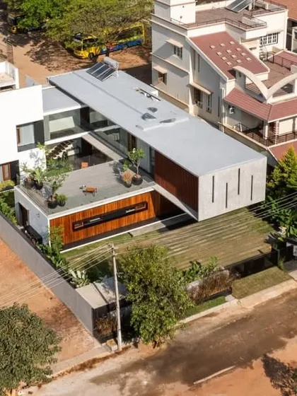 This drone shot reveals the architectural master plan of the Long House. The layout is organized along a linear axis, with the central courtyard and terrace acting as pivotal open spaces that connect the different zones of the home.
