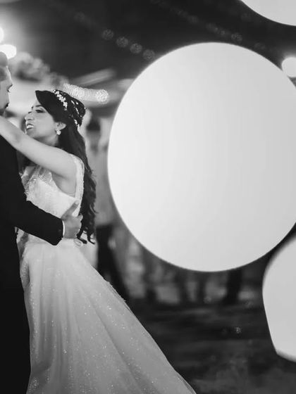 An artistic black and white shot of the first dance, with large bokeh circles creating a dreamy effect. This is a great example of my creative approach.