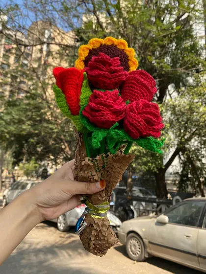 A mix of classic red roses and a single sunflower, creating a bold and beautiful arrangement. A perfect handmade gift for any occasion.
