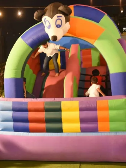 Fun for all ages! A bouncy castle set up on our rooftop lawn for a kids' birthday party.