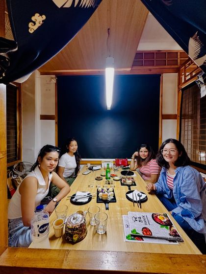 Another view of our gathering, showing the cozy, traditional-style booth of the Korean restaurant. I make sure to capture the unique decor that contributes to the authentic atmosphere.