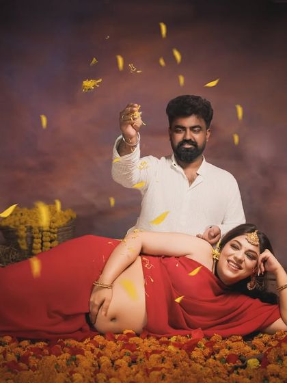 A shower of blessings. The partner playfully showering marigold petals adds a sense of joy and celebration to this traditionally styled portrait.