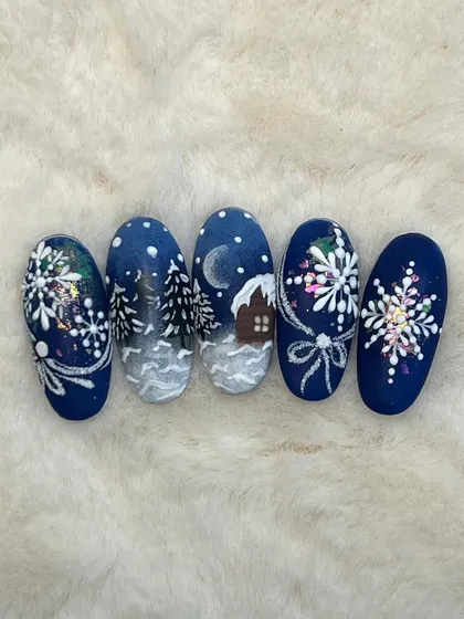 A top-down view of the detailed Christmas landscape nail art. This is a great example of storytelling through nail design.