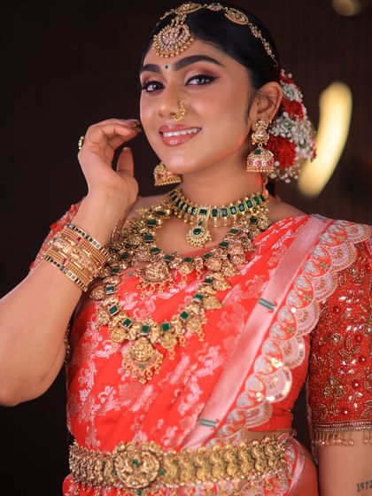 This stunning red floral saree is styled for a high-fashion bridal shoot. The drape is immaculate, designed to look dramatic and beautiful on camera.