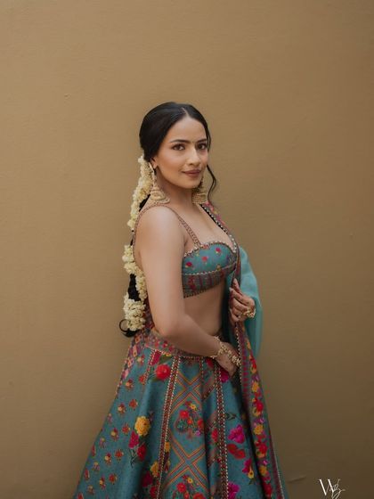Another beautiful portrait showing how the natural makeup look complements the vibrant, floral lehenga.