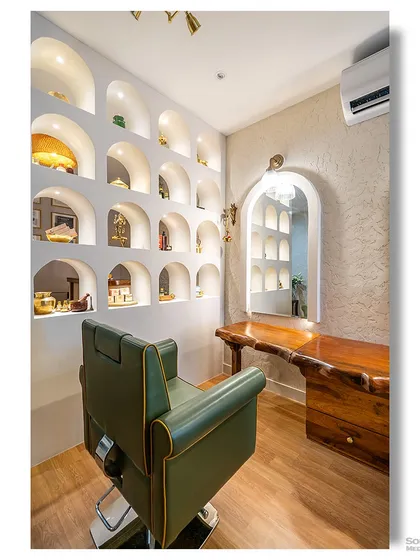 A styling room in a wellness center, featuring a wall of illuminated, arched display niches. The space is designed to be both functional and aesthetically pleasing, with a mix of modern and traditional elements.