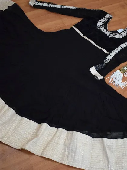 I designed this black and white Anarkali for a client who wanted timeless elegance. The flowing georgette is contrasted with delicate white embroidery on the sleeves and yoke, creating a look that is both classic and striking.