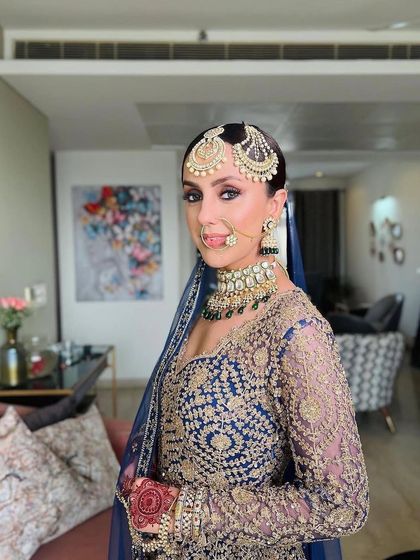 A happy and confident wedding guest. Her makeup is classic and elegant, designed to last all day and night.