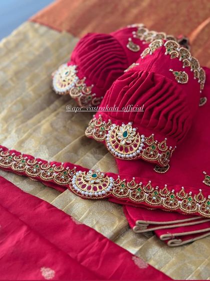 A classic red half-saree set for kids, featuring a blouse with beautifully ruched puff sleeves and a matching embroidered waist belt.