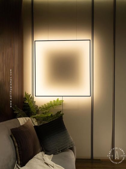 A duplicate of image 106, this image shows the suspended frame light creating a warm and inviting corner in a living room.