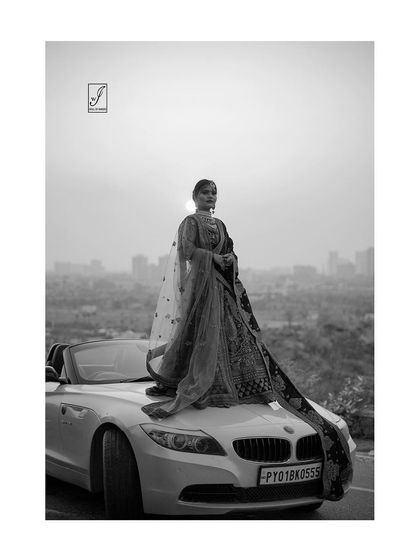 The same powerful scene rendered in classic black and white, focusing on the silhouette, textures, and the dramatic contrast of the setting sun.