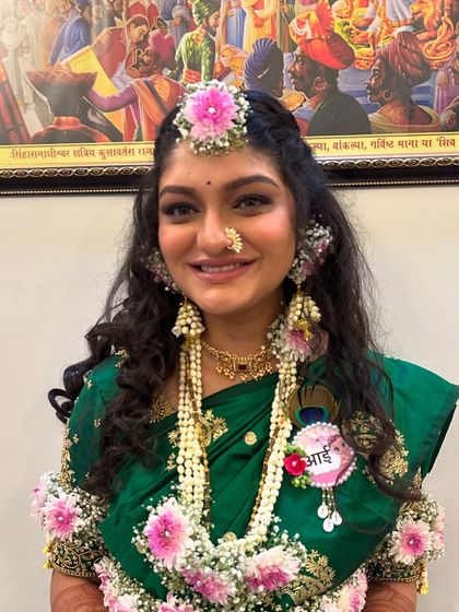 A close-up of the mom-to-be, adorned with fresh floral jewelry for her baby shower. The makeup is kept fresh and radiant.