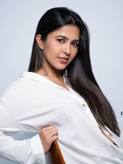 A classic, clean headshot with a simple white shirt.