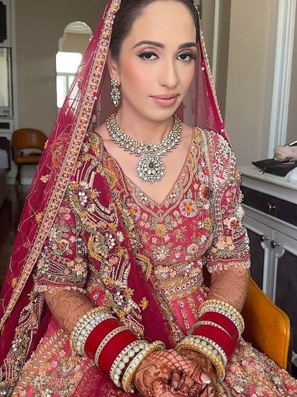 A seated portrait of the bride, looking serene and beautiful. The makeup is flawless from every angle, ensuring she looks perfect in all her wedding photos.
