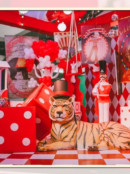A whimsical scene from a circus party, featuring a majestic tiger prop, giant dice, and a nutcracker figure. I layer different elements to create visually rich environments that are exciting to explore.