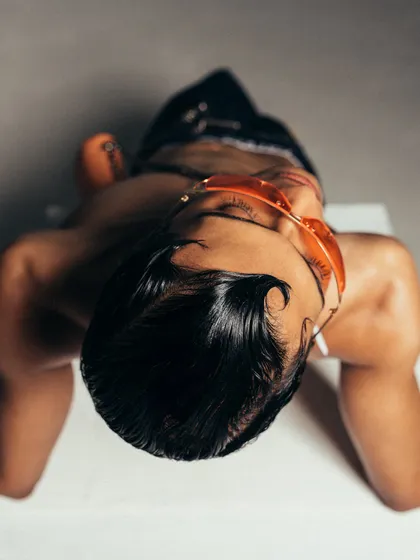 An overhead shot that offers a unique perspective on the model and styling. This artistic composition is designed to be visually disruptive and engaging.
