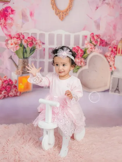 A bubble adds a touch of magic to this pretty-in-pink milestone session. This little girl is enjoying the playful atmosphere.