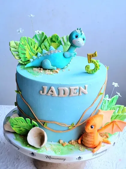 A full view of the dinosaur cake, showing the placement of all the elements.