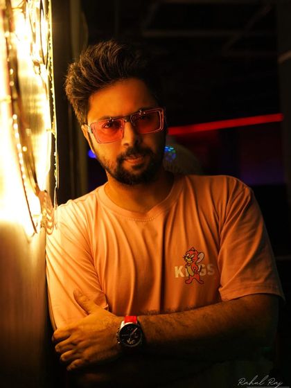 Embrace the chase. A candid, thoughtful portrait taken in the warm glow of neon lights.