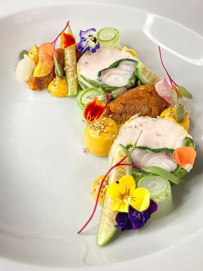 A dish that is as vibrant as it is flavorful. This Ballotine of fish is wrapped in Swiss Chard with a shrimp mousseline, complemented by yuzu pumpkin and pickles. It’s a perfect example of my approach to fine French cooking.