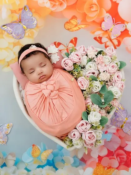 Capturing the peaceful perfection of a newborn. This little one, nestled in a heart of flowers, showcases the delicate, artistic, and safe approach I take for my newborn photoshoots, creating a timeless piece of art.