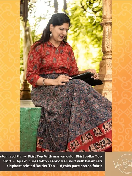 Our customer looking elegant and happy in her custom-designed Ajrakh skirt and top, sitting in a beautiful natural setting.
