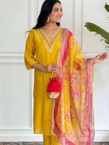 A vibrant mustard kurta set with a contrasting pink and yellow printed dupatta. It's a cheerful and stylish outfit that's perfect for a sunny day.