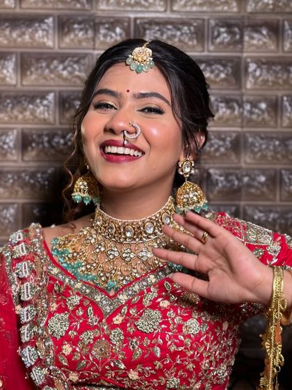 A happy wave from the bride, her entire look is a symphony in red.