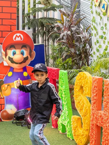 This little guy is ready to party with Mario! We love capturing the excitement of kids meeting their favorite characters at their themed birthday bash.