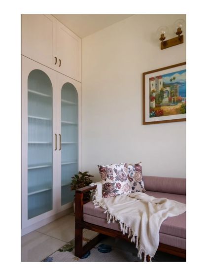 Another view of the study's sofa-bed and arched storage cabinet, creating a serene and multi-purpose corner in the home.