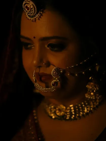 This shot highlights the intricate details of the bridal jewelry, like the nath and maang tikka, and how the makeup works in harmony with them to complete the look.