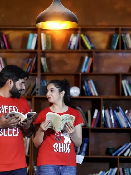 A fun and quirky shoot in a library or bookstore setting. The matching t-shirts add a playful touch to this unique pre-wedding concept.