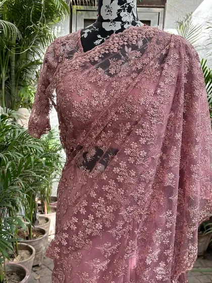 A closer look at our powder pink saree. The intricate floral embroidery on the net fabric is all done by hand in my studio.