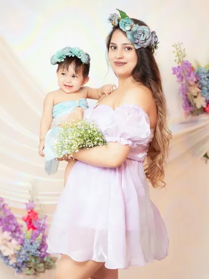 A mother and daughter share a moment in our floral-themed setup, perfect for our special Mother's Day mini sessions.
