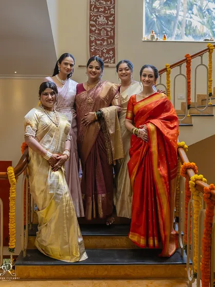 A lovely formal portrait of the bride and her girls, beautifully framed by the architecture of her home.