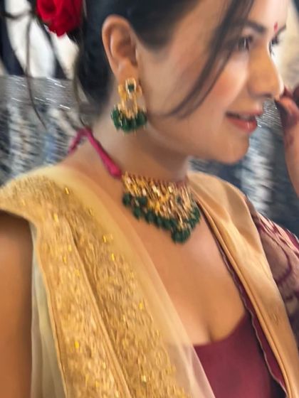 This image shows the beautiful detailing of the green beaded necklace set. It sits perfectly and adds a touch of traditional elegance to her festive attire.