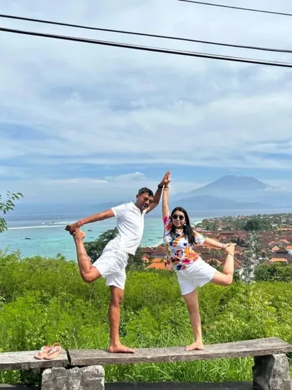 Bali bound. Finding balance together with a partner Natarajasana (Dancer's Pose) overlooking a stunning Bali landscape. Yoga is a journey best shared.