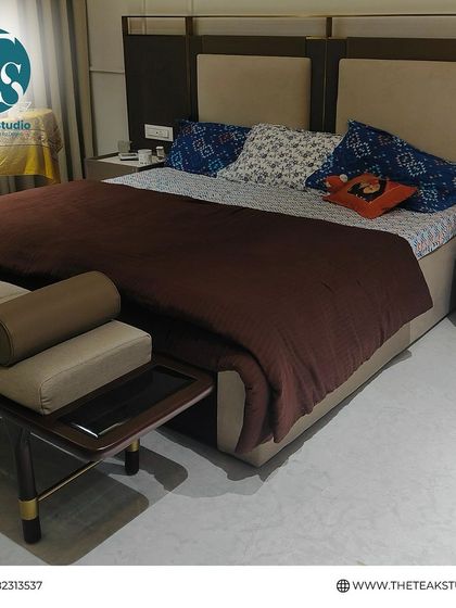 A fully furnished view of the beige upholstered bed and matching bench, showing how it looks once styled by the client.