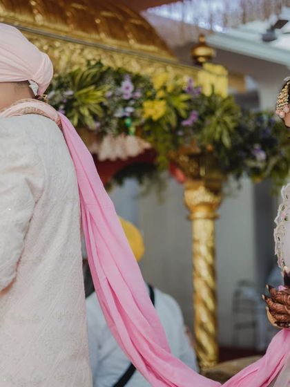 The 'palla' ceremony in a Sikh wedding, where the bride's father places the stole in the groom's hand, symbolizing giving his daughter away.