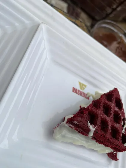 A close-up of our popular Red Velvet waffle with a cream cheese filling. The vibrant color and rich taste make it a standout dessert at any party.