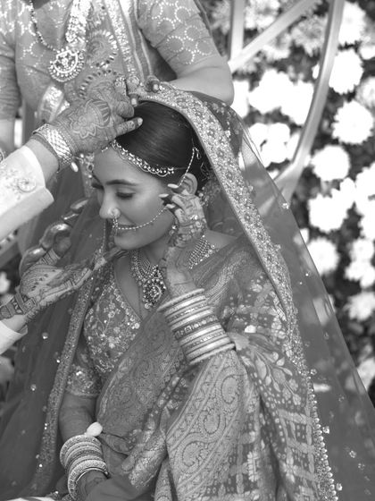 A black and white shot of a sacred moment during the wedding ceremony, adding a timeless and classic feel to the ritual.