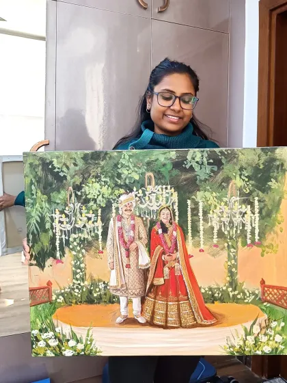 Presenting the finished painting at the end of a live wedding event in Gurugram.