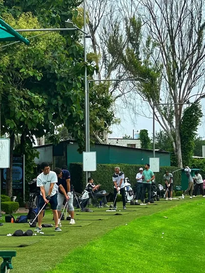 The driving range is buzzing with energy as players of all levels practice side-by-side.