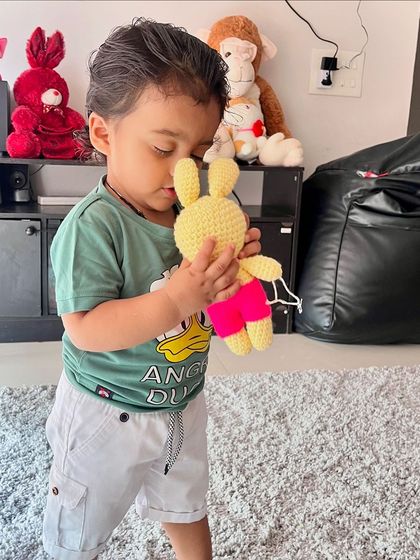 This little boy loves his new yellow bunny. My toys are soft and safe, perfect for children to hold and cuddle.