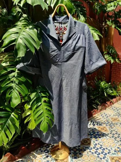 A versatile denim-look dress that can be styled in so many ways. The relaxed fit and classic collar make it a perfect canvas for a statement necklace, like the red dragon piece shown here.