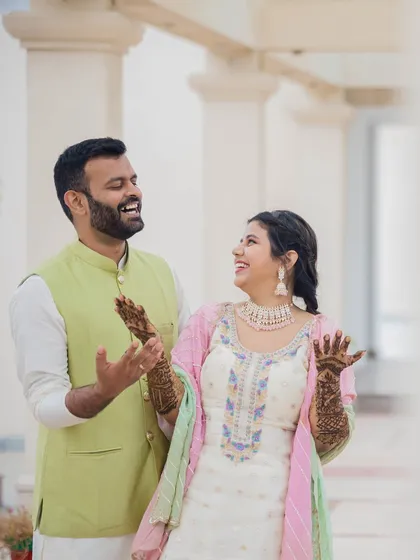 A candid moment of laughter between the couple during their Mehendi. These genuine interactions are what make the memories so special.